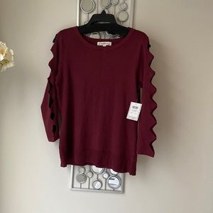 Burgundy sweater with triangle arm slits